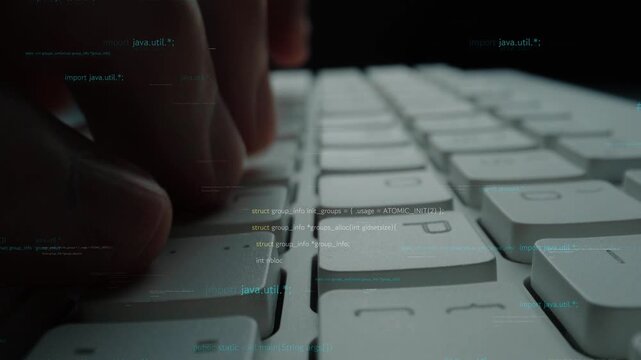 A close-up view of hands typing on a white keyboard with a backdrop of digital code, representing modern technology and digital communication in a dark setting. Xenic