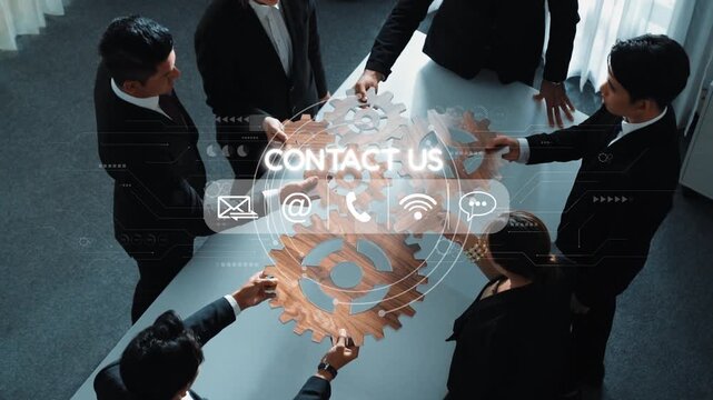 A professional business team collaborates in a modern office setting, discussing strategies with digital connectivity elements symbolizing communication and outreach. Raster