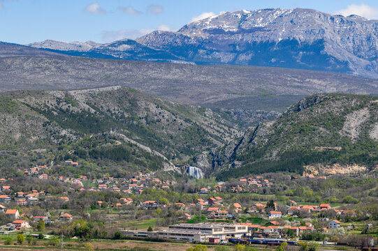 Krcic waterfall and snow-capped Dinara mountain seen from Knin fortress, Dalmatia, Croatia