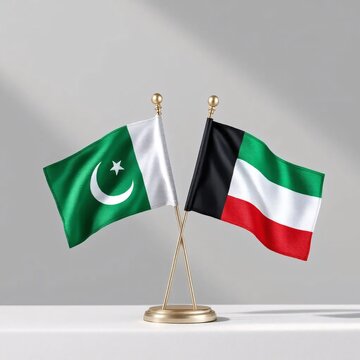 Pakistani and Kuwaiti flags on a small stand. National symbols representing diplomatic relations and international cooperation.