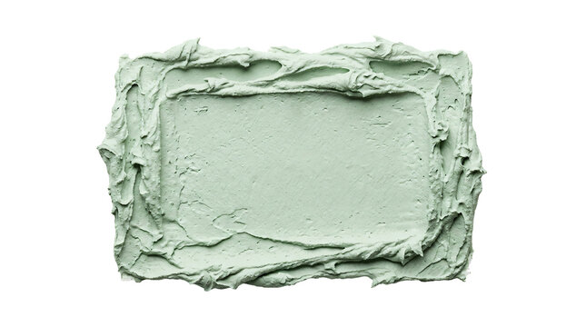 Thick light green cosmetic clay smear spread in a rectangular frame shape with textured edges and smooth center on transparent background