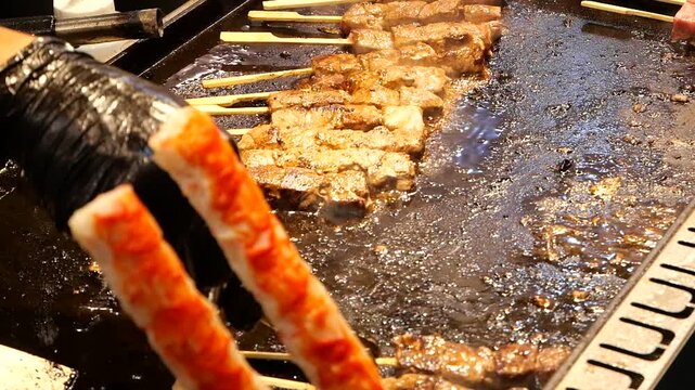 Japanese Teppanyaki Kushiyaki of grilling meat on griddle