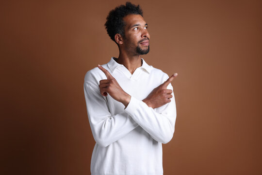 Choice. Man pointing upwards on brown background