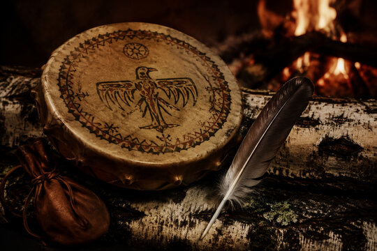 Shamanic frame drum with painted hide on birch log, spiritual and ritual tradition concept