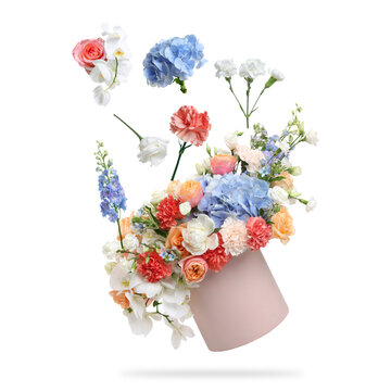Bouquet in box and flowers flying in air against white background