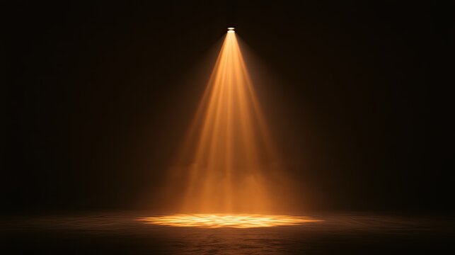 Intense orange spotlight illuminates a smoky stage floor in darkness