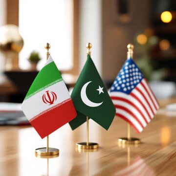 Small desk flags of Iran, Pakistan and USA on a wooden table for international diplomacy.