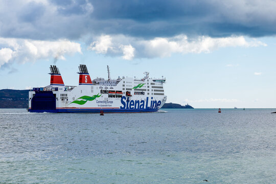 Stena line "Adventurer" ferry sails from Dublin Port, Irish Sea, travelling to Holyhead, UK. Car, freight and passenger transport vessel. Dark clouds above ship. Ireland