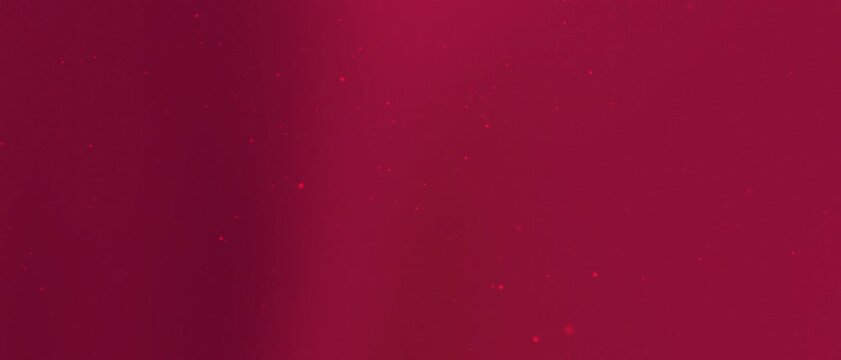 Abstract background featuring out of focus maroon particles and bokeh lights moving gently. Seamless loop for motion graphics and visual effects.
