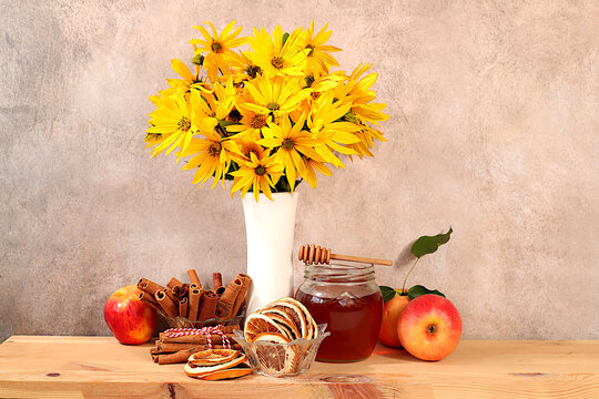 Autumn greeting and gratitude concept. Autumn banner with a beautiful bouquet of rudbeckia in a vase, honey, apples, dried orange, cinnamon and star anise on an elegant gradient background,