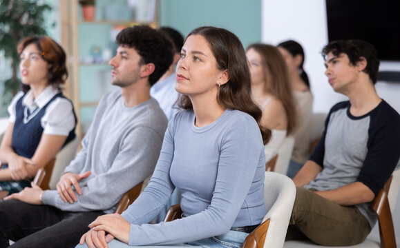 Students of the faculty of psychology watch the presentation carefully. Young people are sitting at a lecture in the training center