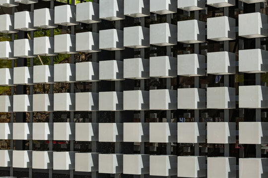 Alleghe, Italy. Repeating geometric white facade elements creating a modern architectural pattern