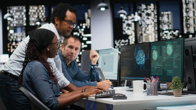 Engineering team fights a DDoS attack in the office to protect servers from malware while startup colleagues work together against a virus sent by a cybercriminal that is disrupting company systems.