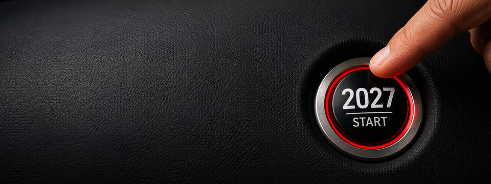 2027 start button with hand for New Year goals, business motivation, achievement, automotive industry and new beginning.