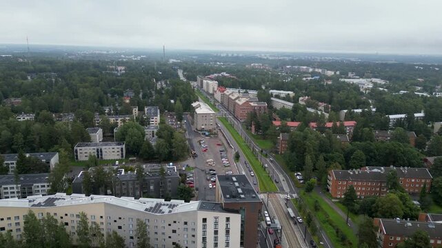 Aerial drone video of Patola in Helsinki, Finland during summertime, showing residential buildings, green trees, streets, and the peaceful Nordic urban landscape from above.