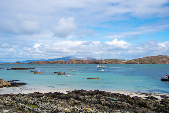 Small Boats Anchored off the coast of Iona on a summer day, Inner Hebrides, Scotland, UK