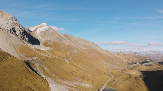Aerial view of a mountain range and valley on a clear day. Scenic natural landscape with peaks and slopes.