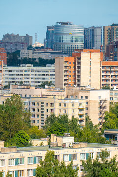Modern city skyline panorama with residential apartment buildings under blue sky.
