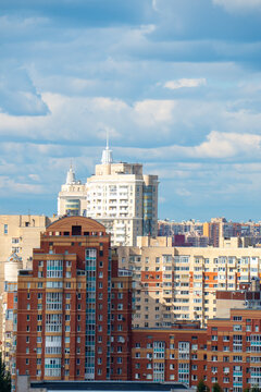 Modern city skyline panorama with residential apartment buildings under blue sky.
