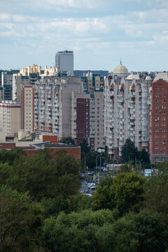 Modern city skyline panorama with residential apartment buildings under blue sky.
