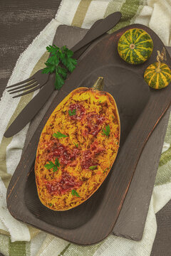 Baked spaghetti squash with spices, herbs and tomato sauce. Gluten free food, healthy dinner, vegan