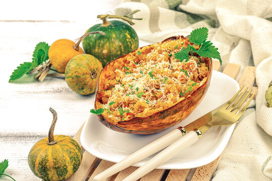 Baked spaghetti squash with spices, herbs and tomato sauce. Gluten free food, healthy dinner, vegan