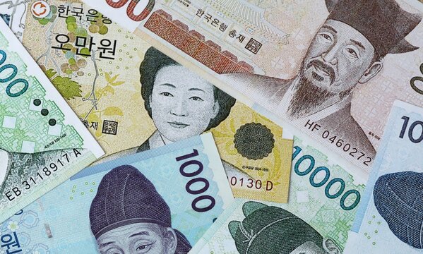 South Korean won money bills in pile on table. South Korea KRW currency cash close up