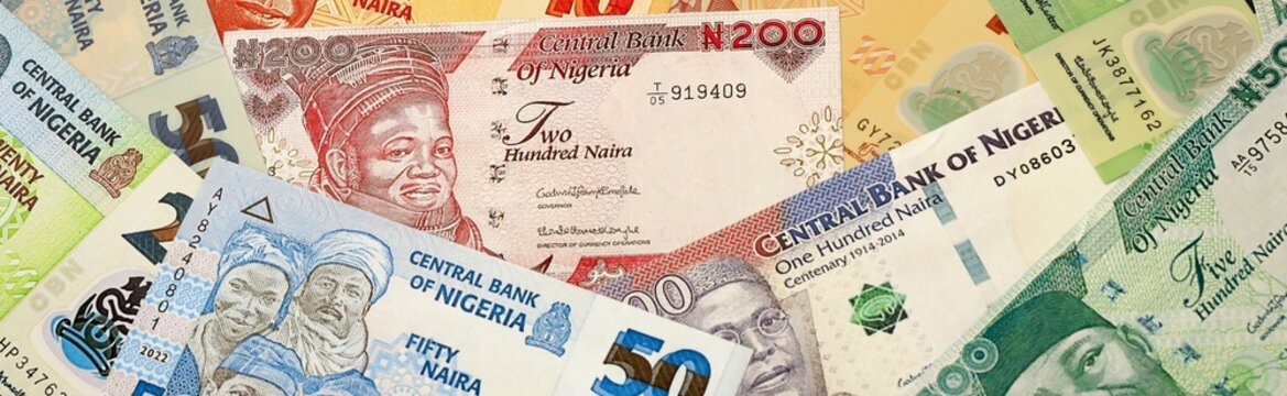 Nigerian naira money bills in pile on table. Nigeria NGN currency cash close up