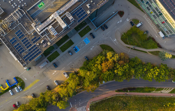 Aerial view of data centre with solar panels on the roof, parking lot with cars, and surrounding greenery in Gdansk, Pomeranian Voivodeship, Poland.