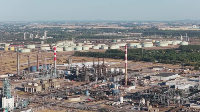 Aerial view of industrial pipes and equipment at an oil refinery plant. Heavy manufacturing infrastructure for petroleum production.