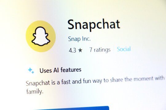 Snapchat app page with logo and rating on computer screen close up. Social media messaging platform with AI features. Digital communication technology and mobile application concept for editorial use