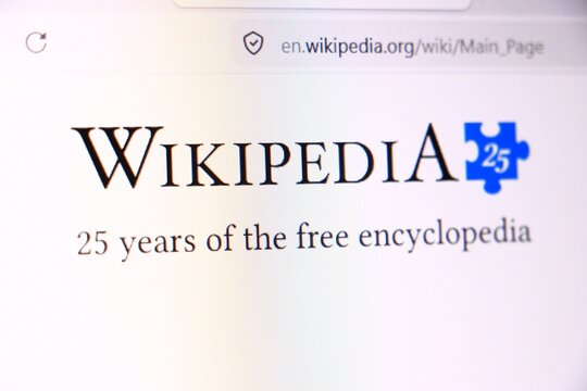 Wikipedia logo on computer screen celebrating 25 years of the free online encyclopedia. Anniversary of the popular internet knowledge website displayed in web
