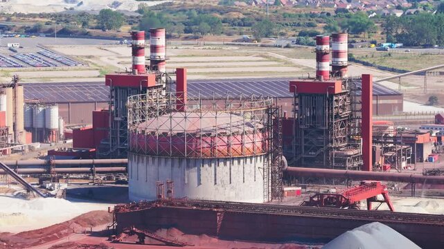 Aerial drone view of a heavy metallurgical plant producing steel. Industrial facility with manufacturing buildings and infrastructure.
