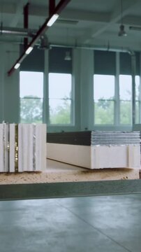 Vertical video: Starting slider panning panels on particleboard shelf, showing metal edges