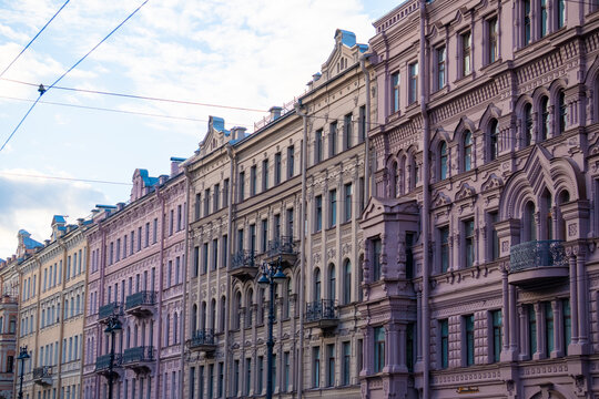 Classic historic building stone facade with art nouveau ornaments and windows pattern close up.
