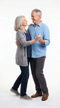 Happy senior couple dancing together on white background