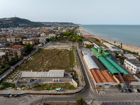 Aerial view of the historic Ex Stadio Fratelli Ballarin site near the sandy beach and urban coastline of San Benedetto del Tronto, Marche, Italy.
