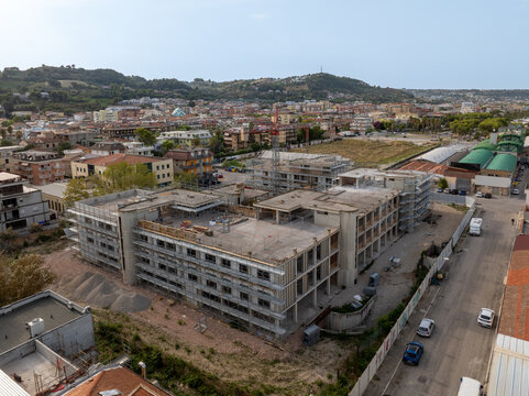 Aerial view of the construction site at the former Ex Stadio Fratelli Ballarin with scaffolding and a crane surrounded by the urban landscape of San Benedetto del Tronto, Marche, Italy.
