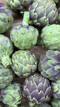 Fresh artichokes close up at farmers market top view