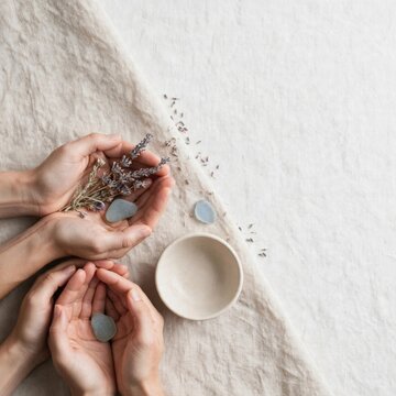 Wellness Ritual: Hands, Lavender, and Smooth Stones Flat Lay