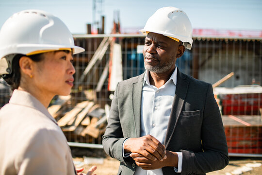 Construction professionals discussing project on site
