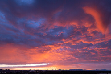Fototapeta premium Dramatic Pink and Purple Storm Clouds Glowing at Sunset