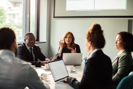 Business team discussing strategy in modern conference room
