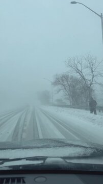 Driving on a street through a winter snow storm