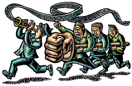 a director plays an instrument which generates film stock and a group holding a protest fist shaped battering ram follow him