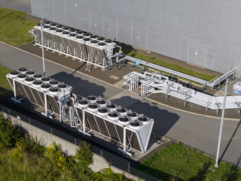 Aerial view of AI data center cooling system with industrial fans and piping infrastructure located outside a modern facility in Krakow, Lesser Poland Voivode, Poland.