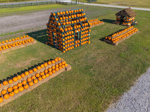Aerial view of Trask Family Farms featuring a large pumpkin structure and rows of pumpkins on hay bales in a field in Castle Hayne, North Carolina, United States.