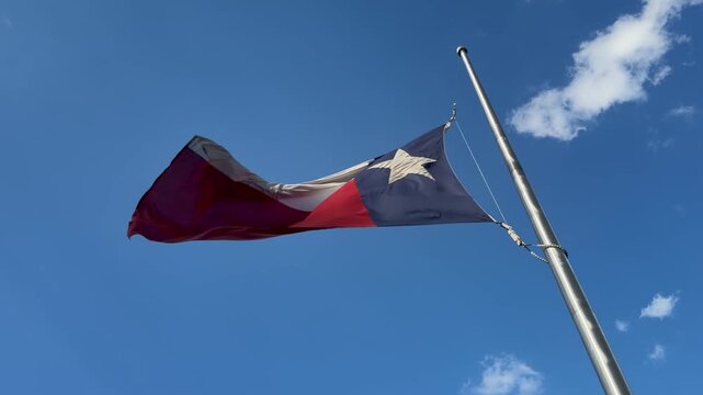 Texas flag flying at half staff
