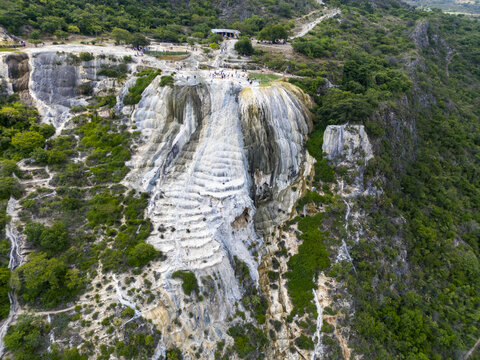 Aerial view of the petrified waterfalls at Hierve el Agua with mineral formations, natural pools, and lush green vegetation in Oaxaca de Juarez, Oaxaca, Mexico.