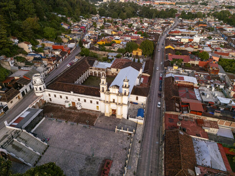Aerial view of the Templo de Santo Domingo de Guzman with its colonial architecture, red tile roofs, and stone plaza in the early morning light in San Cristobal de las Casas, Chiapas, Mexico.